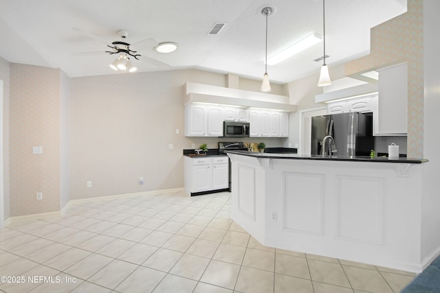 kitchen with hanging light fixtures, kitchen peninsula, ceiling fan, stainless steel appliances, and white cabinets