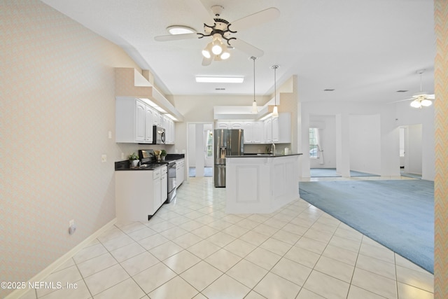 kitchen with white cabinetry, light colored carpet, stainless steel appliances, and ceiling fan