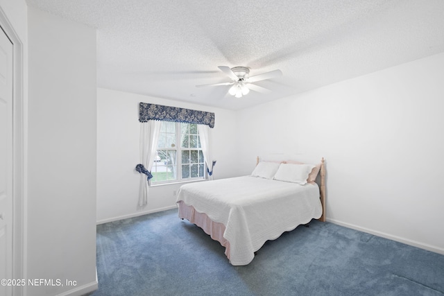 carpeted bedroom featuring ceiling fan and a textured ceiling