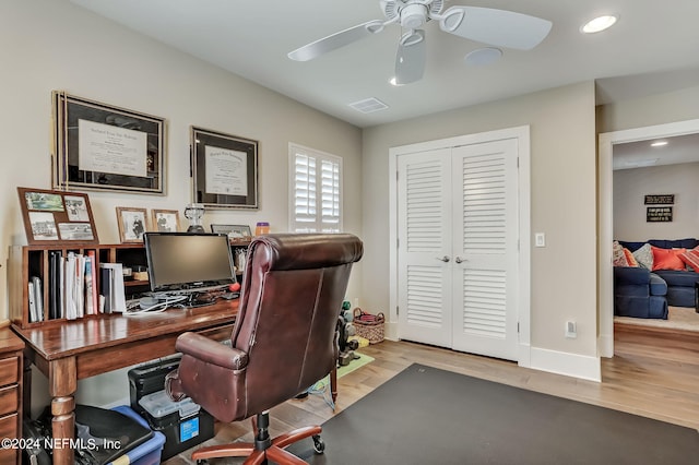 office space with light hardwood / wood-style floors and ceiling fan