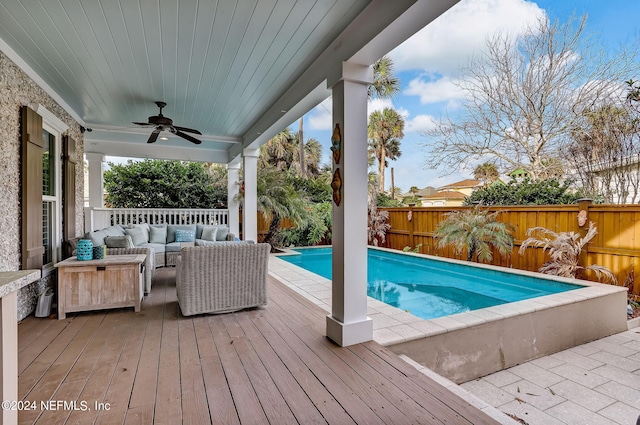 view of swimming pool with an outdoor hangout area, ceiling fan, and a deck