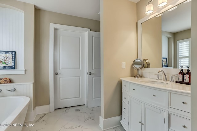 bathroom featuring vanity and a washtub