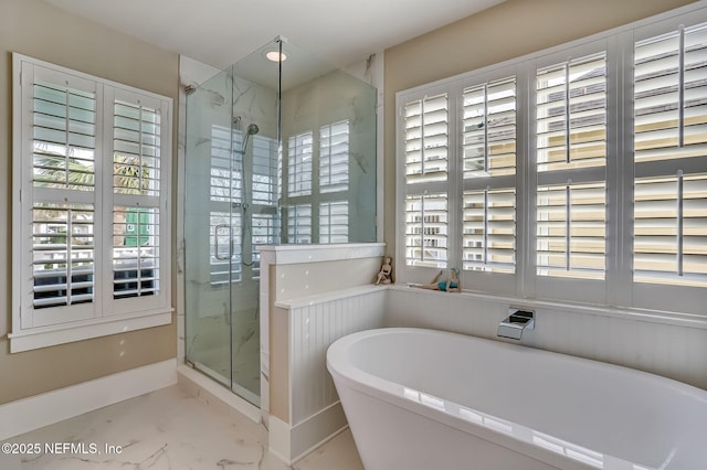 bathroom featuring shower with separate bathtub