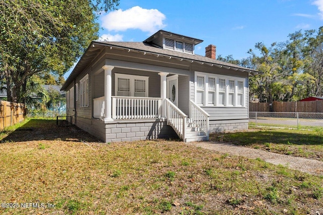 bungalow-style house featuring a front yard