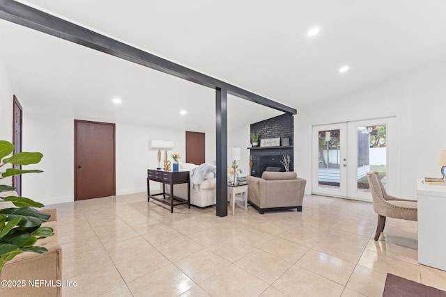 tiled living room featuring a fireplace, vaulted ceiling, and french doors