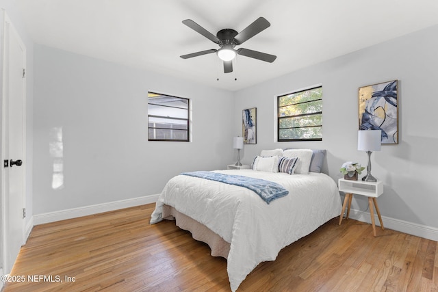 bedroom with hardwood / wood-style floors and ceiling fan