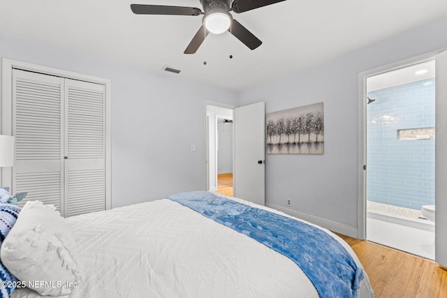 bedroom featuring wood-type flooring, a closet, ceiling fan, and ensuite bathroom