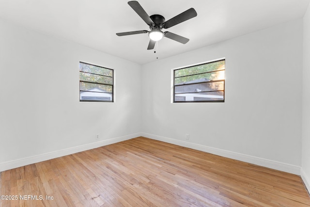 spare room featuring plenty of natural light, ceiling fan, and light hardwood / wood-style flooring