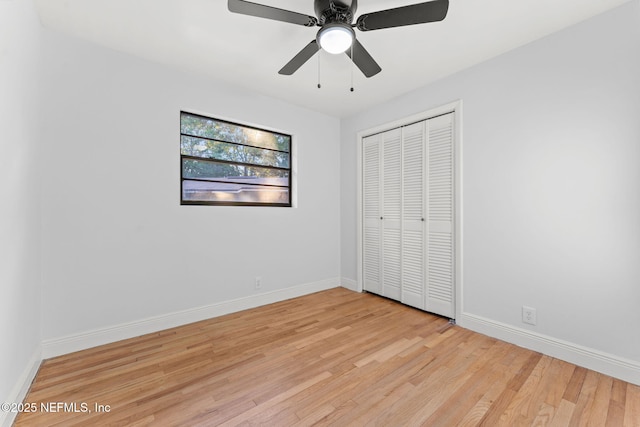 unfurnished bedroom with ceiling fan, a closet, and light hardwood / wood-style flooring