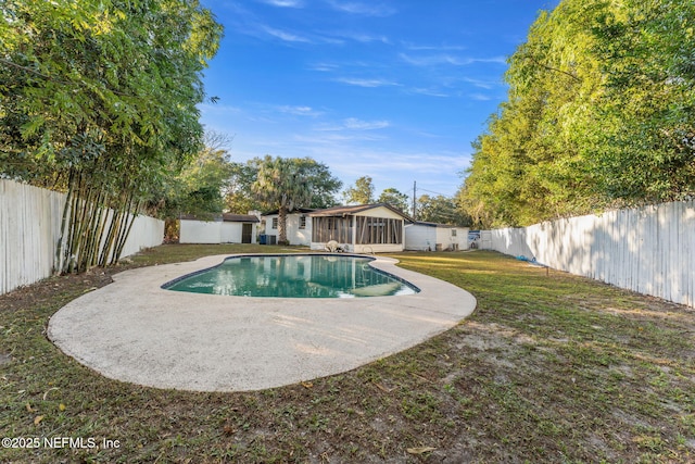 view of swimming pool featuring a yard, a sunroom, and a patio area