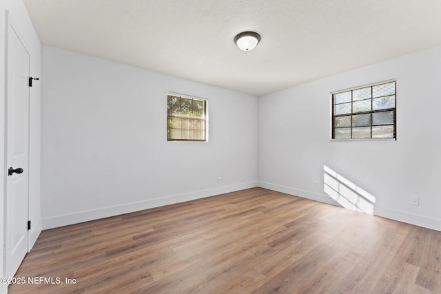 spare room with light hardwood / wood-style floors