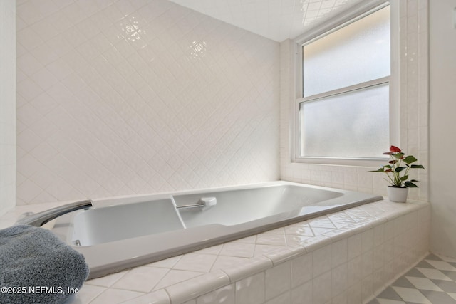 bathroom featuring tile walls and tiled tub