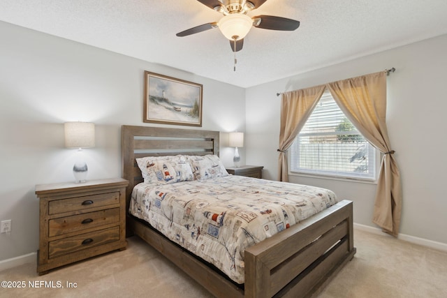 bedroom featuring light carpet, ceiling fan, and a textured ceiling