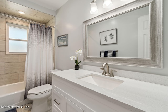 full bathroom featuring shower / bath combination with curtain, vanity, and toilet