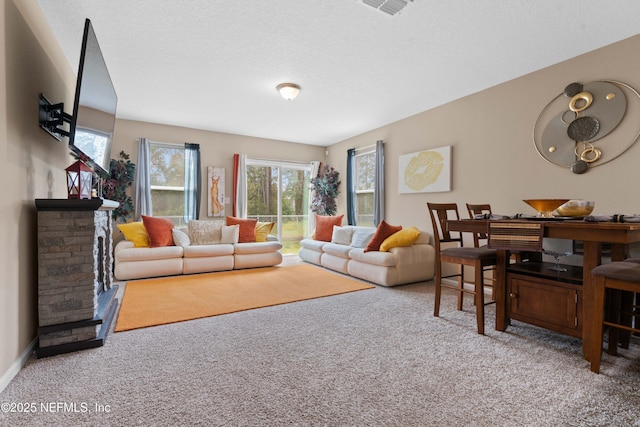 carpeted living room featuring a textured ceiling