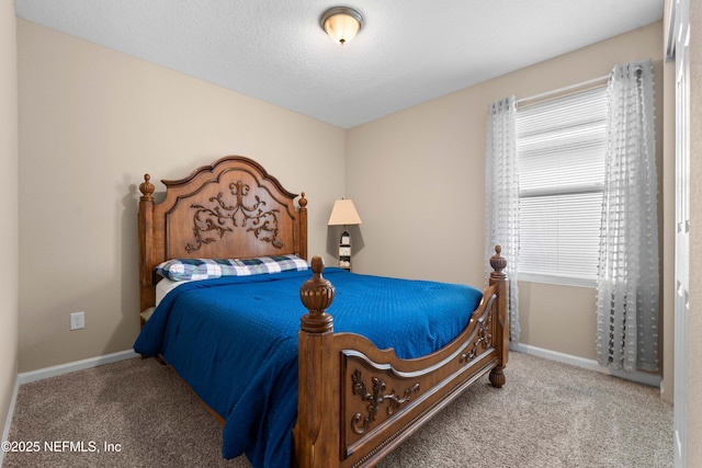 bedroom featuring carpet flooring and a textured ceiling