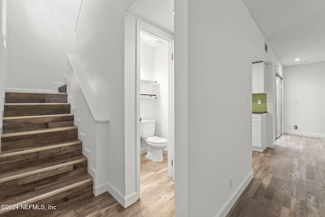 interior space featuring recessed lighting, visible vents, baseboards, stairway, and light wood-type flooring