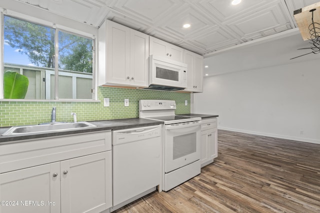 kitchen with white appliances, tasteful backsplash, an ornate ceiling, white cabinetry, and a sink