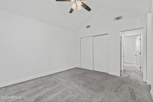 unfurnished bedroom with high vaulted ceiling, a closet, carpet, and visible vents