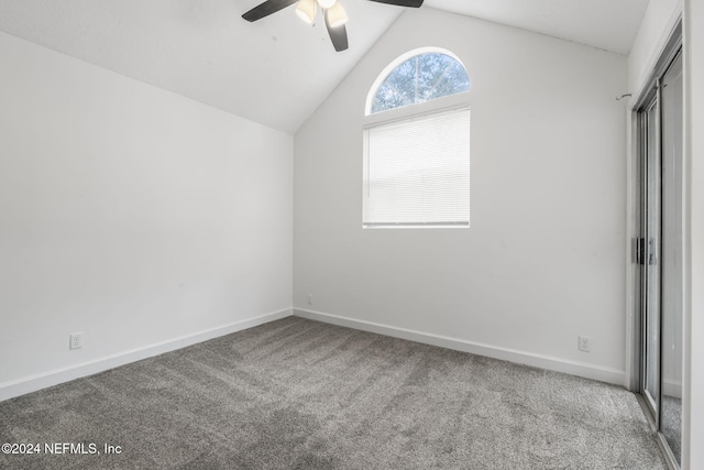 unfurnished bedroom with carpet floors, vaulted ceiling, baseboards, and ceiling fan