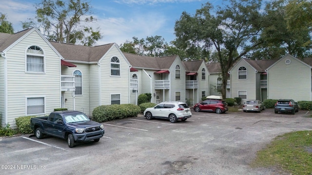 uncovered parking lot featuring a residential view