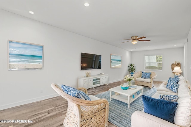 living area featuring recessed lighting, baseboards, and wood finished floors