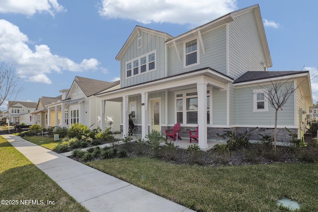 view of front facade with a front yard and covered porch