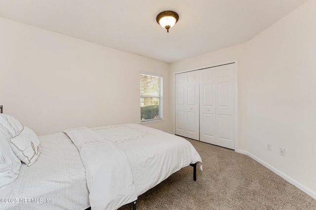 bedroom featuring carpet, a closet, and baseboards