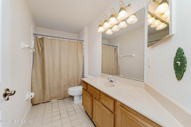 bathroom with tile patterned flooring, vanity, and toilet