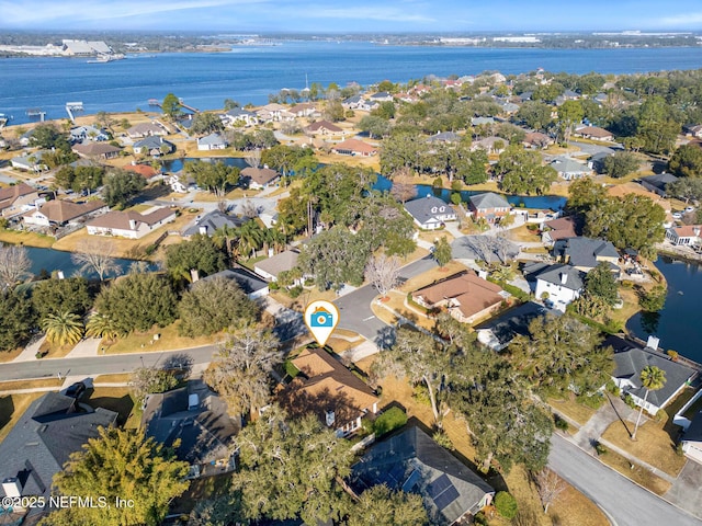 drone / aerial view featuring a residential view and a water view