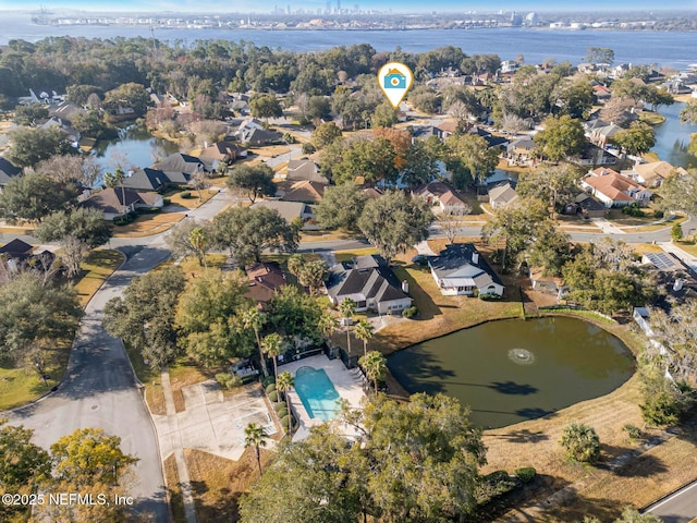 drone / aerial view with a water view and a residential view