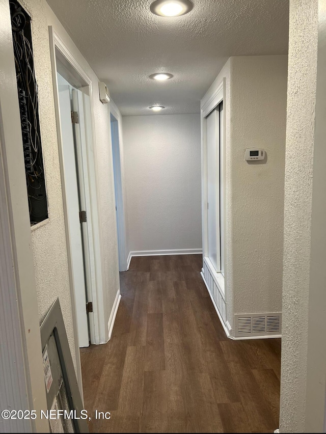 816 Middleton Rd, Jacksonville, FL 32211 - hall featuring wood finished floors, a textured wall, and a textured ceiling