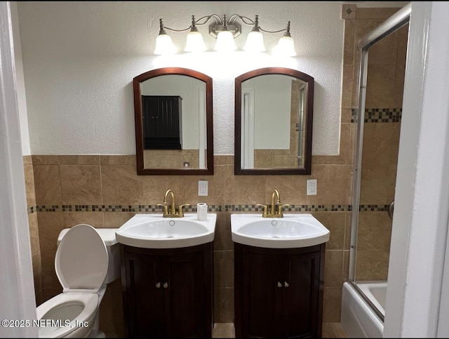 816 Middleton Rd, Jacksonville, FL 32211 - full bath featuring two vanities, tile walls, and bath / shower combo with glass door