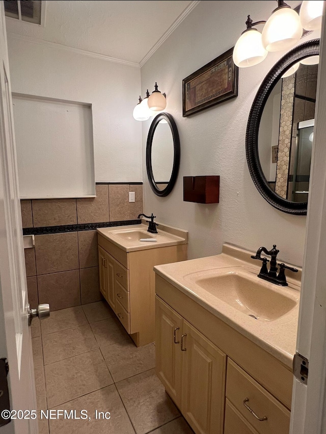 816 Middleton Rd, Jacksonville, FL 32211 - full bath with ornamental molding, tile patterned floors, tile walls, and two vanities