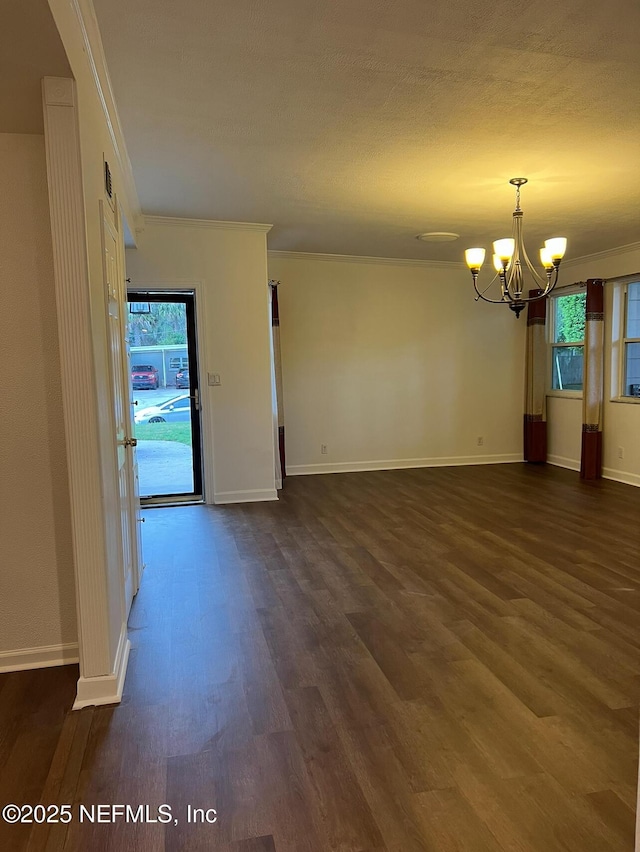 816 Middleton Rd, Jacksonville, FL 32211 - empty room featuring a chandelier, dark wood-style flooring, ornamental molding, and plenty of natural light