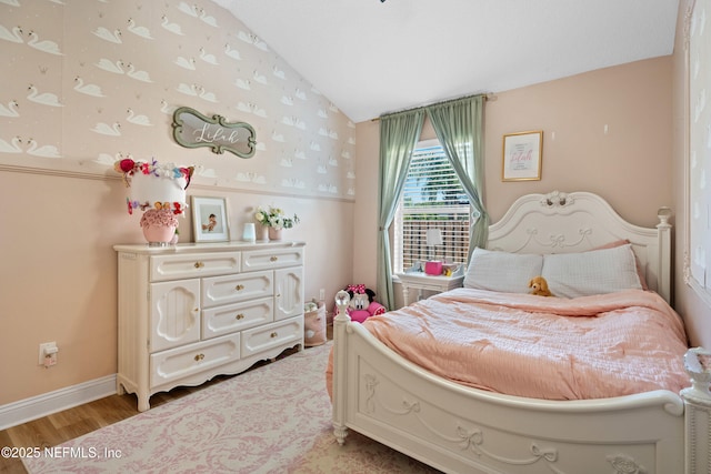 bedroom featuring vaulted ceiling and light hardwood / wood-style flooring