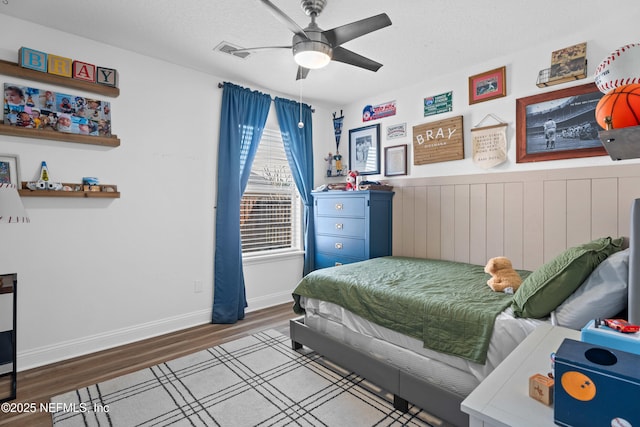 bedroom featuring ceiling fan, light hardwood / wood-style floors, and a textured ceiling