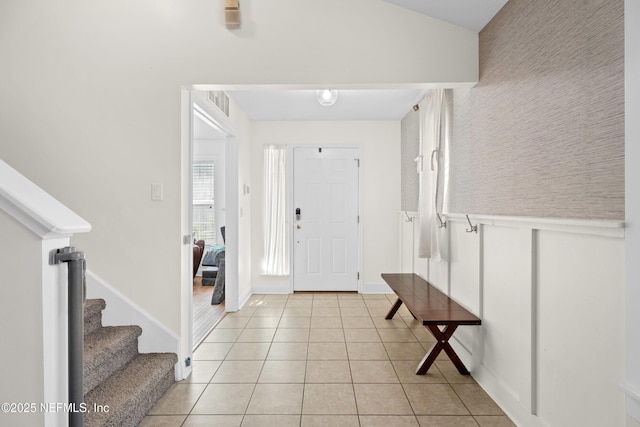 entrance foyer featuring lofted ceiling and light tile patterned floors