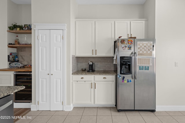 kitchen featuring white cabinetry, stainless steel refrigerator with ice dispenser, and wine cooler