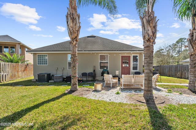 rear view of house with a patio, central AC unit, and a lawn