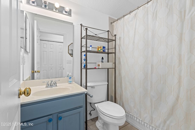 bathroom with vanity, toilet, tile patterned floors, a textured ceiling, and a shower with shower curtain