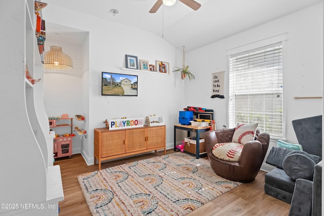 sitting room featuring lofted ceiling, hardwood / wood-style floors, and ceiling fan