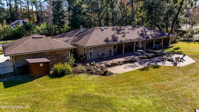 back of property featuring a yard and a patio area