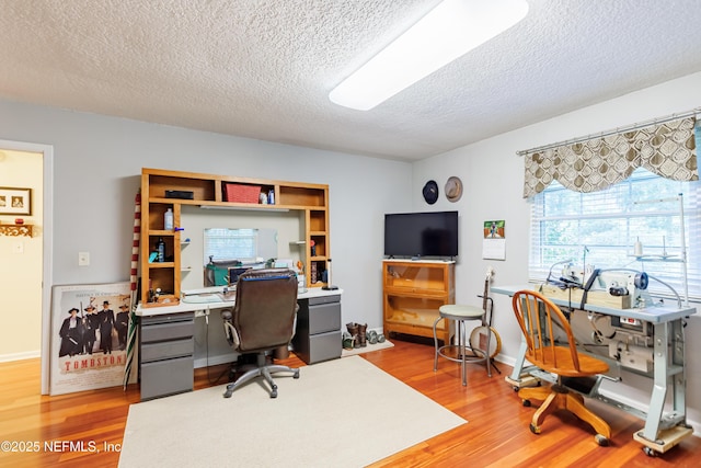 home office with hardwood / wood-style flooring and a textured ceiling