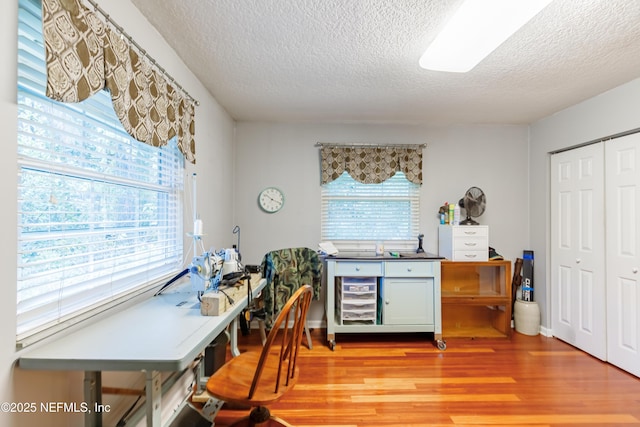 office featuring light hardwood / wood-style floors and a textured ceiling