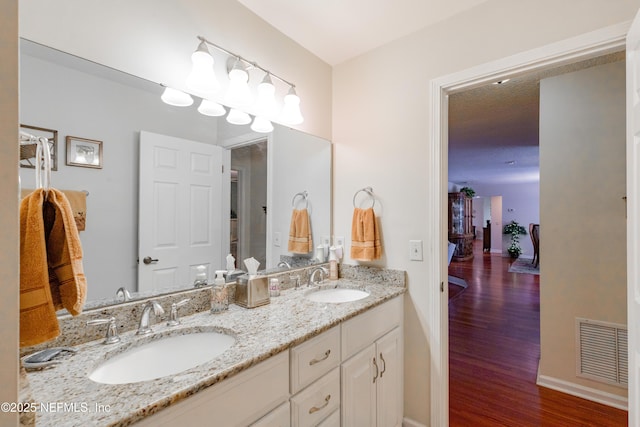 bathroom with vanity and hardwood / wood-style floors