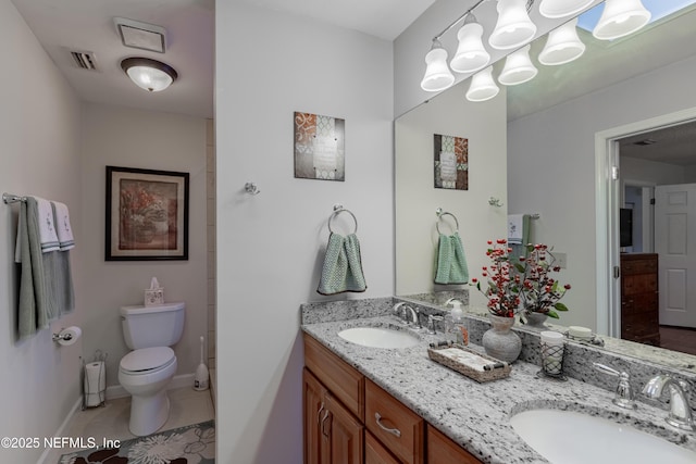 bathroom featuring vanity, tile patterned floors, and toilet