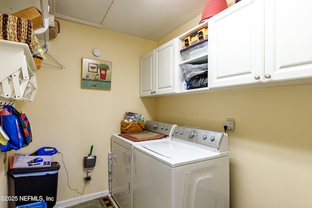 laundry room featuring cabinets and washer and clothes dryer