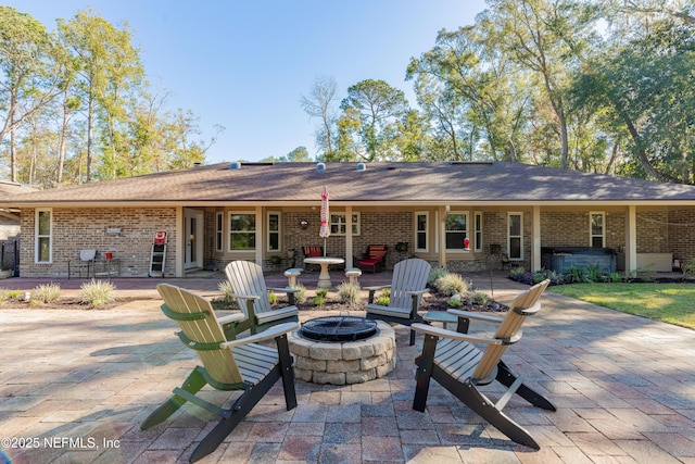 rear view of house with a patio area and a fire pit