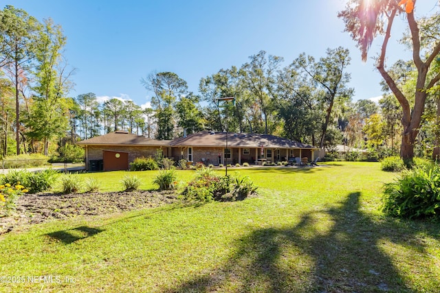 rear view of property with a lawn